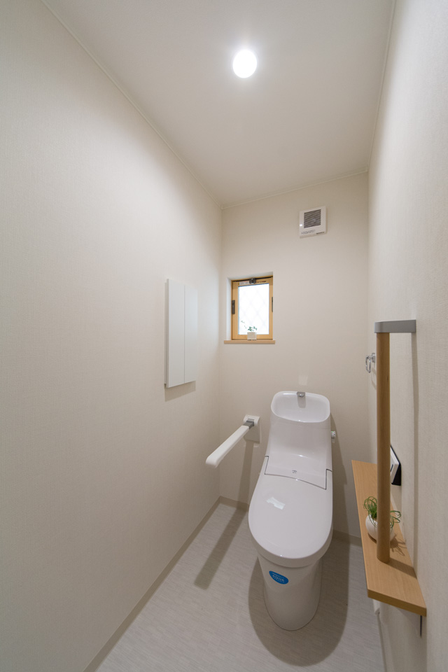 1Fトイレ。跳ね上げ式の手摺は空間の有効利用及び利用者様の自立を支援し、使わない時は上げられる為便利です。