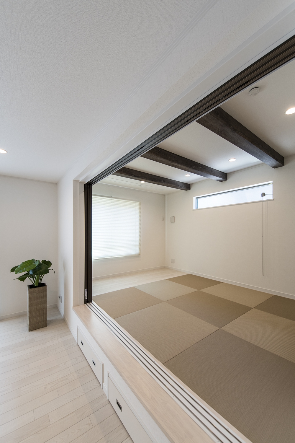 天井に化粧梁を設え、モカベージュ色の畳を市松敷きにした、モダンな空間の小上がり和室。